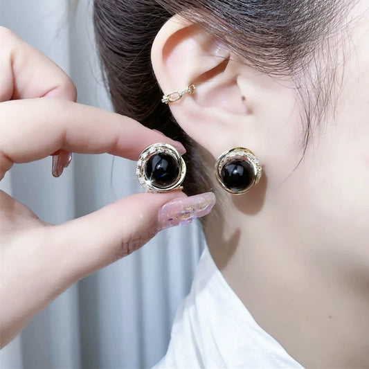 Temperament black pearl earrings ear buckles women's high-end fashion round red bean silver needle earrings retro Hong Kong style earrings